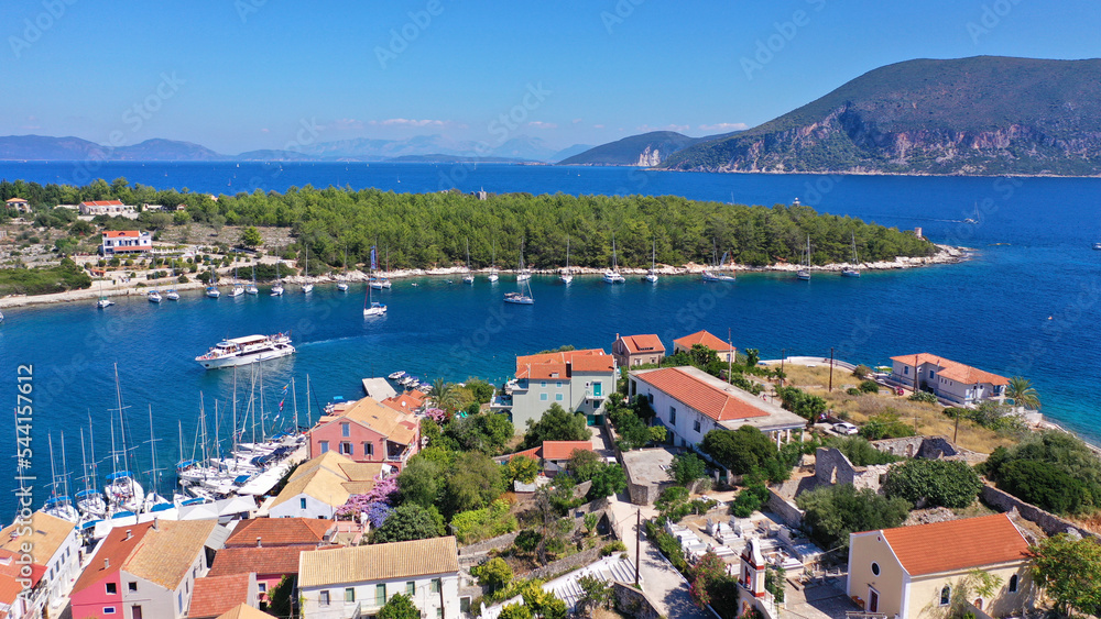 Aerial drone photo from iconic picturesque fishing village and bay of Fiskardo with beautiful traditional houses of Ionian architecture, Cefalonia island, Greece
