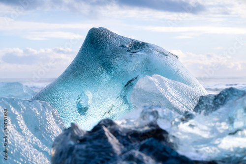 Diamond beach, Iceland. Pieces of icebergs with clear ice. Reflections and light in the ice during sunset. A popular destination for a trip to Iceland. photo