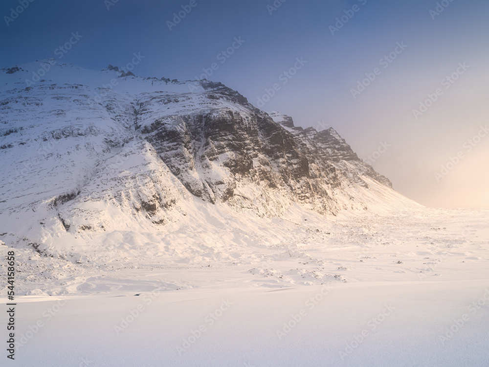 Mountain landscape in Iceland. Winter time. A walk on the glacier. High mountains and clouds at dawn. Travelling through Iceland in a Vatnajokull National Park.