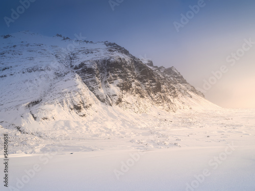 Mountain landscape in Iceland. Winter time. A walk on the glacier. High mountains and clouds at dawn. Travelling through Iceland in a Vatnajokull National Park.