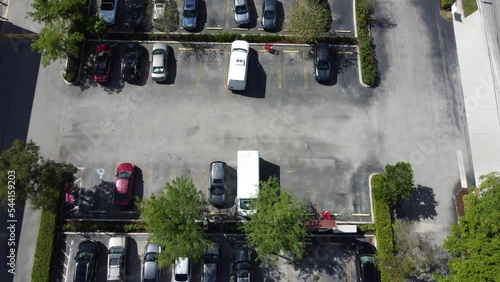 Air view of parking lot with many cars parking and driving.