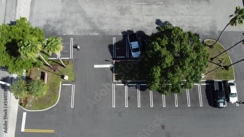 Air view of parking lot with many cars parking and driving.