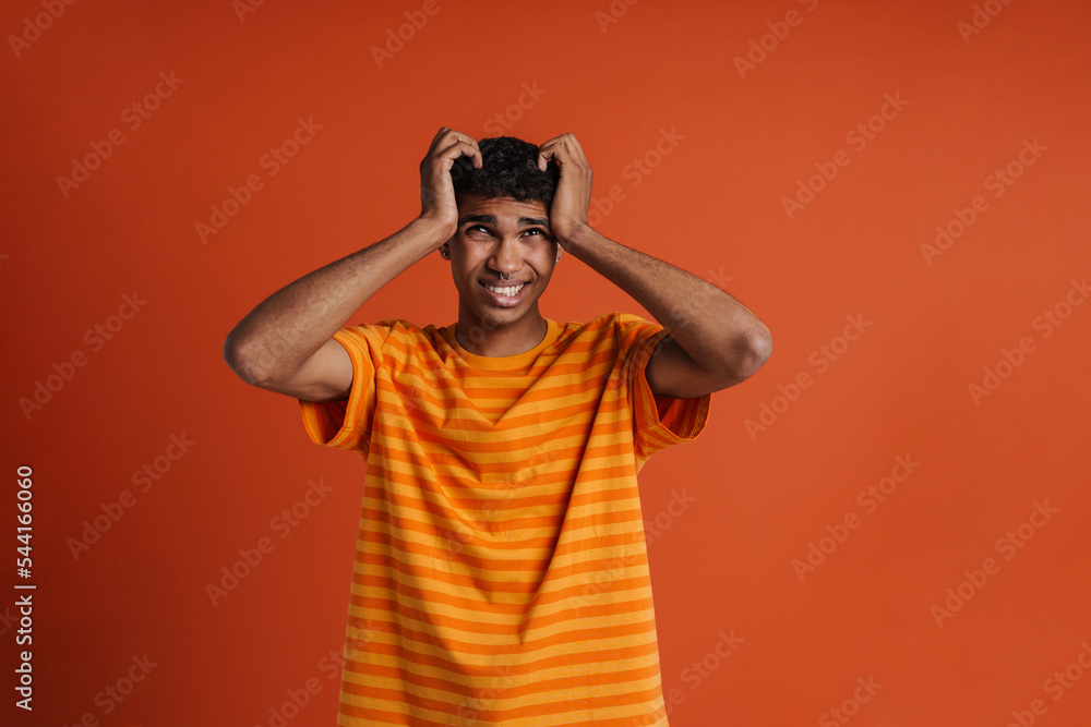 Young handsome stressed african man holding his head