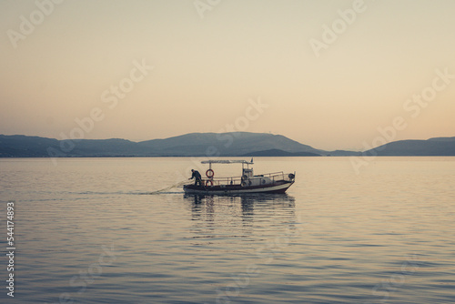 fishing boat at sunset © Γιώργος Μπελεβέντης