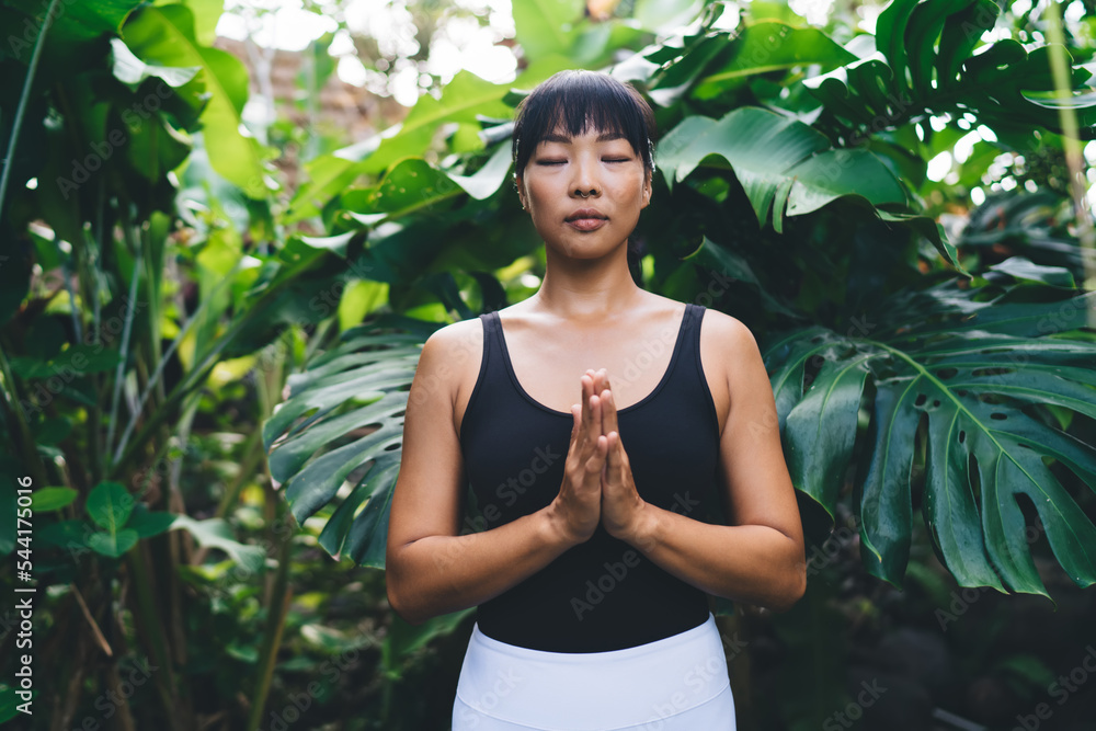 Asian girl practice yoga in garden on Bali island Asian girl practice yoga in garden on Bali island