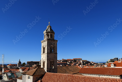 slim tower above the Dominican Monastery with classic red tiled rooftops inside the old town of Dubrovnik, Croatia 