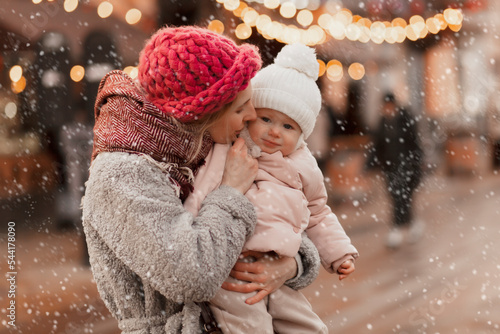 young mother with baby in christmas holidays, winter concept, happy holiday family