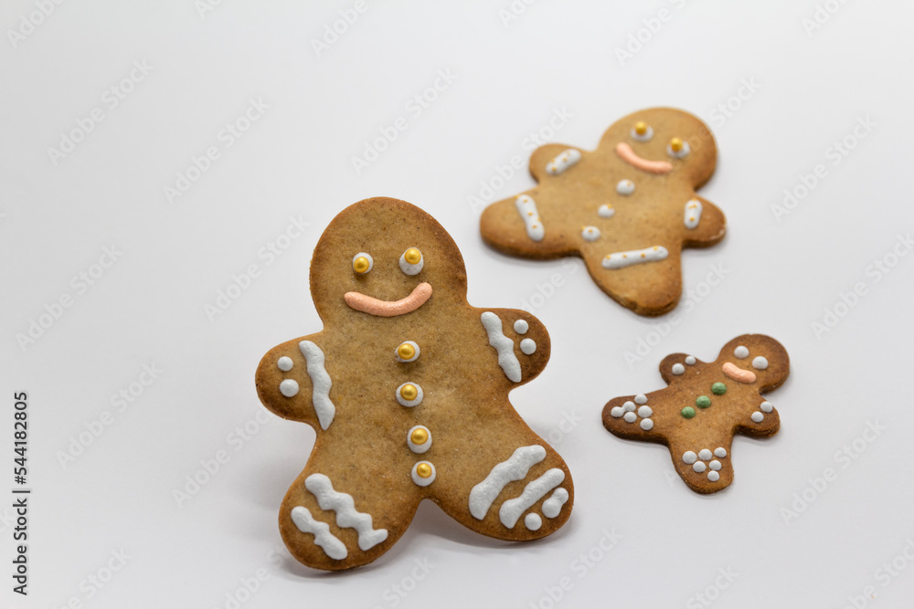 gingerbread man cookies decorated with icing sugar on white background. Christmas food, pastry background. New Year theme. Merry Christmas and Happy New Year Holidays greeting card, frame, banner