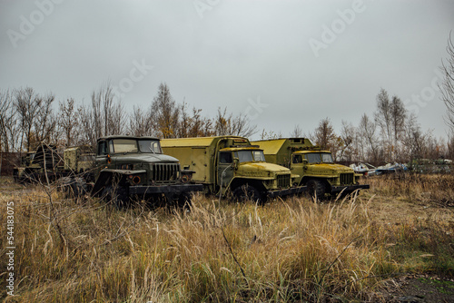 Old abandoned rusty military trucks at the base