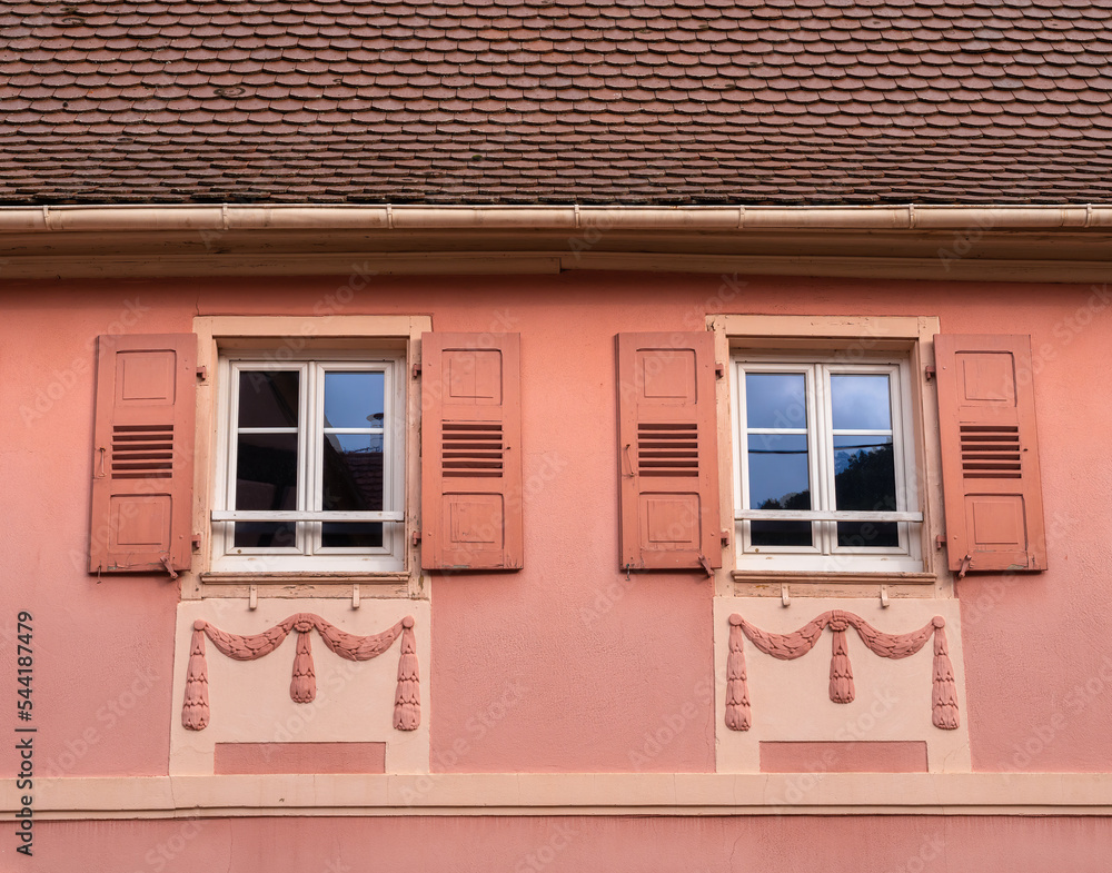 Decorated facade of an old house in Gueberschwihr in Alsace, France