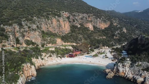 Aerial view of gorgeous Buyuk Chakil (black pebble) beach with emerald clear waters and boats, Kas, Turkey photo