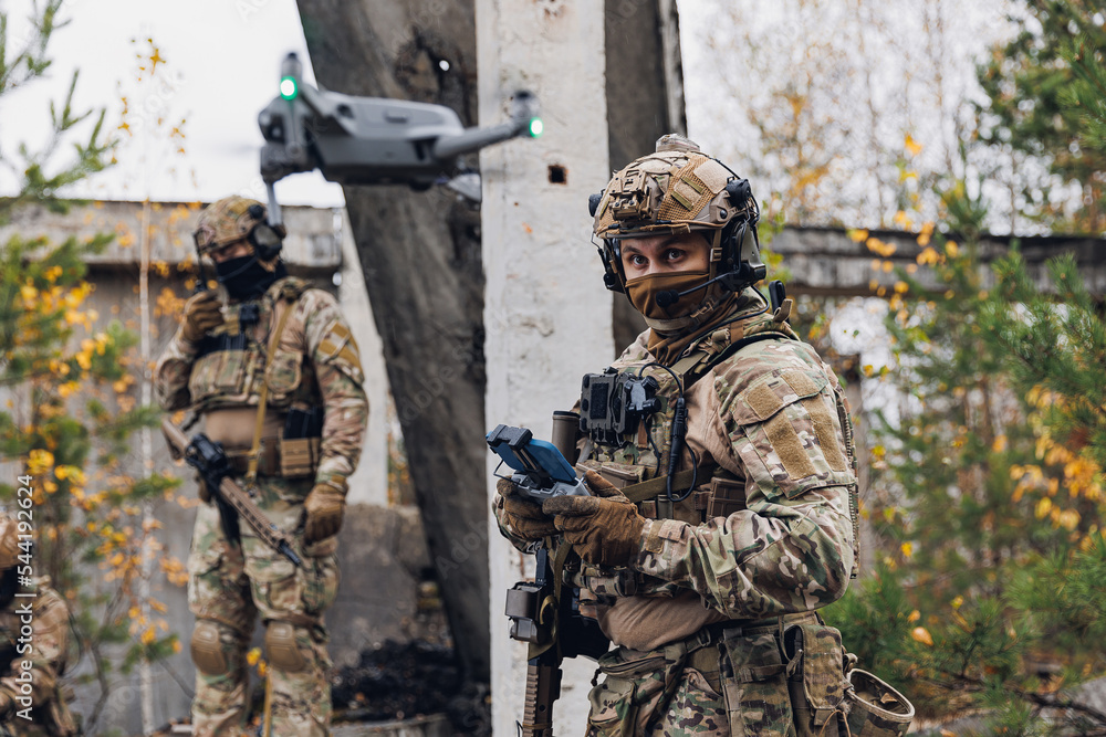 Reconnaissance Operations Military soldier controls drone for reconnaissance operation of enemy ...