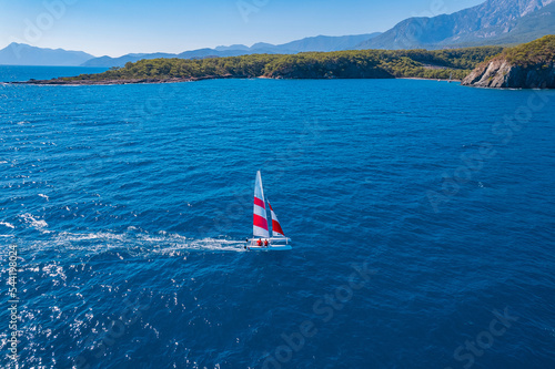 Aerial view beautiful white yacht wirh sail on clear blue sea in Turkey. Concept sport travel by drone