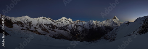 Wide panorama of the Himalaya mountains after sunset. Mountain range with Machapucchare  Fishtail  and Annapurna III peaks.