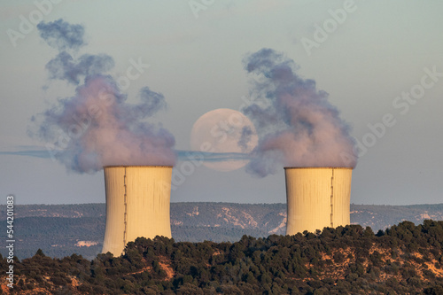 The full moon of November, known as Beaver Moon, rises over the cooling towers of a Nuclear Power Plant. photo