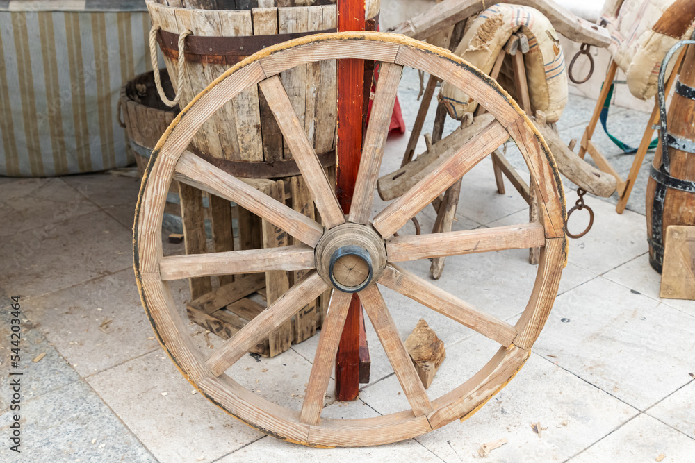 outdoor scene with a tillage wagon wheel in foreground. sustainable economy outdoor scene with a tillage wagon wheel in foreground. sustainable economy