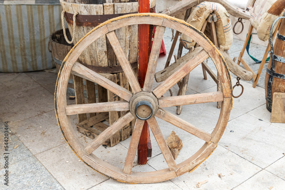 outdoor scene with a tillage wagon wheel in foreground. sustainable economy