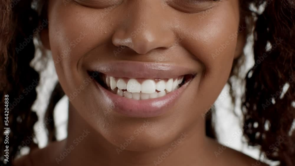 Professional dental hygiene. Close up portrait of young pretty african american woman smiling widely to camera Professional dental hygiene. Close up portrait of young pretty african american woman smiling widely to camera