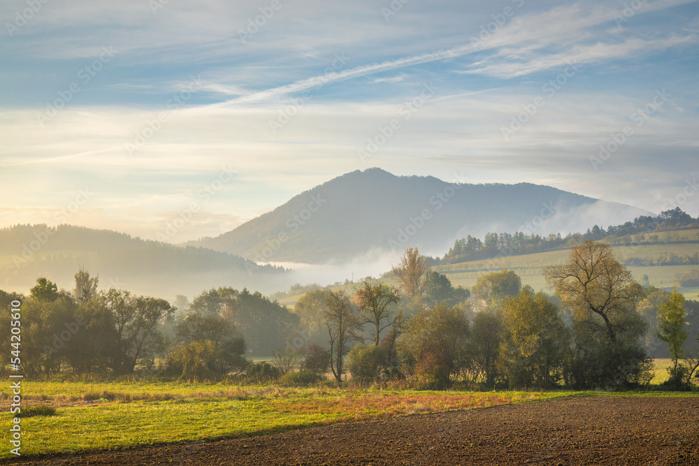 Rural landscape in an autumn foggy morning. Northwest of Slovakia, Europe.