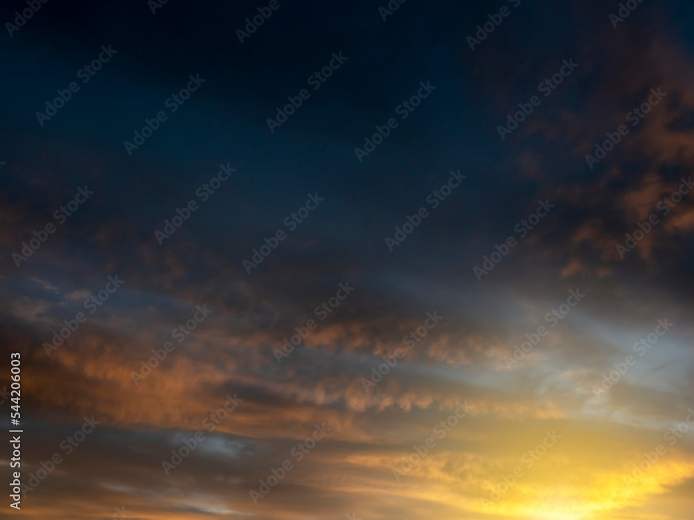 Dramatic sunset sky for design purpose of sky replacement. Nature background. Rich dark blue and warm orange color tone.