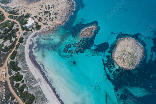 Fototapeta Naklejka Na Ścianę i Meble -  Best beach in Europe with turquoise waters with sand and rocks seen from the air with a drone.