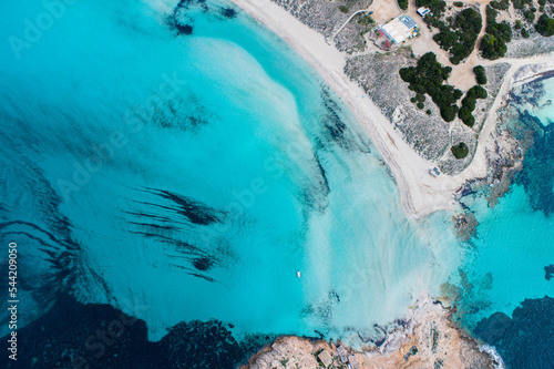 Best beach in Europe with turquoise waters with sand and rocks seen from the air with a drone.