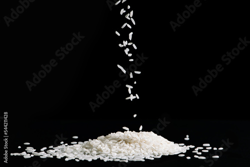 Tablou pe pânză Raw white rice is falling on table