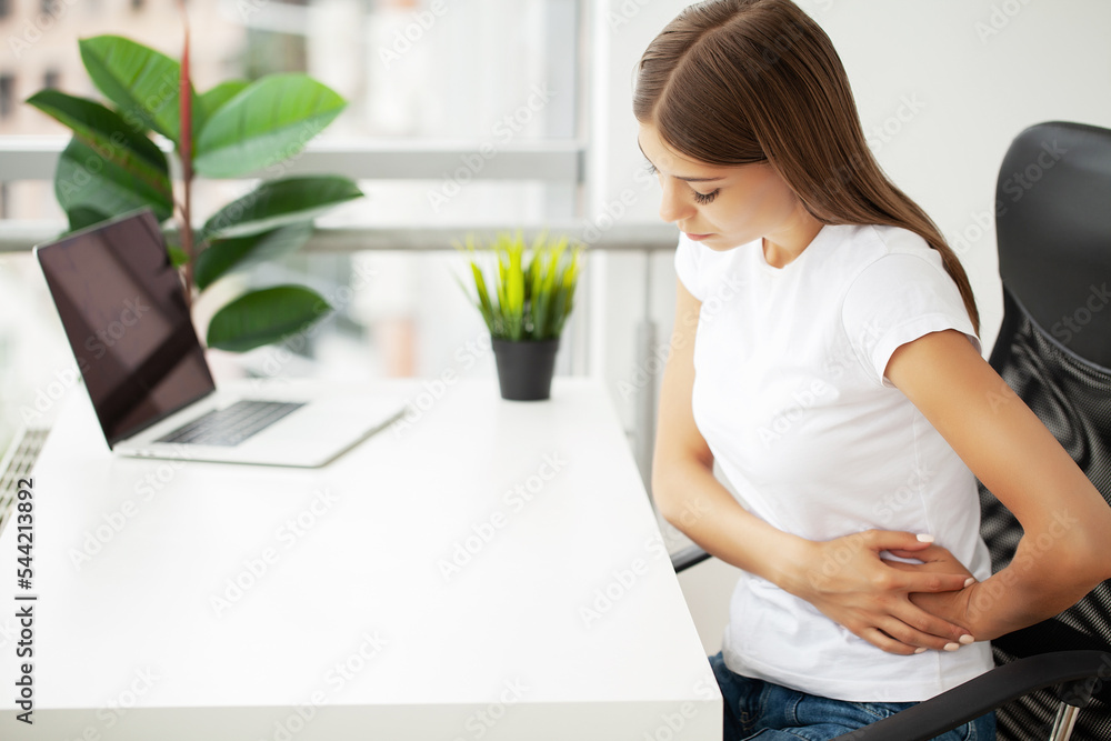 Business woman feeling painful from stomach ache illness during working at office Business woman feeling painful from stomach ache illness during working at office