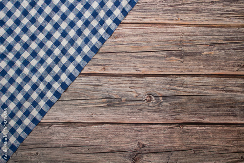 Blue and white checkered tablecloth on a rustic wooden table