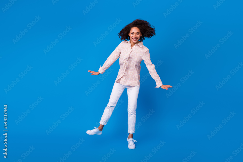 Full length photo of funky sweet girl dressed pink blouse smiling dancing having fun isolated blue color background Full length photo of funky sweet girl dressed pink blouse smiling dancing having fun isolated blue color background