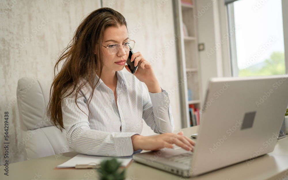 One woman caucasian businesswoman work in the office making phone call One woman caucasian businesswoman work in the office making phone call