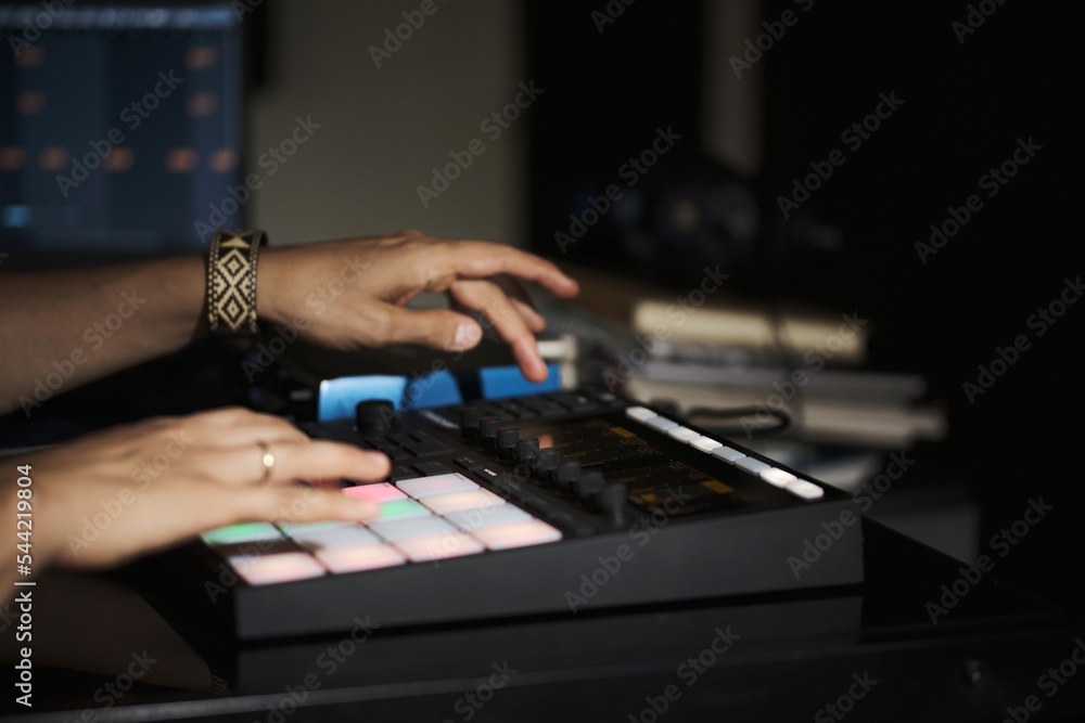 man's hands playing on a beats machine in a home recording studio man's hands playing on a beats machine in a home recording studio