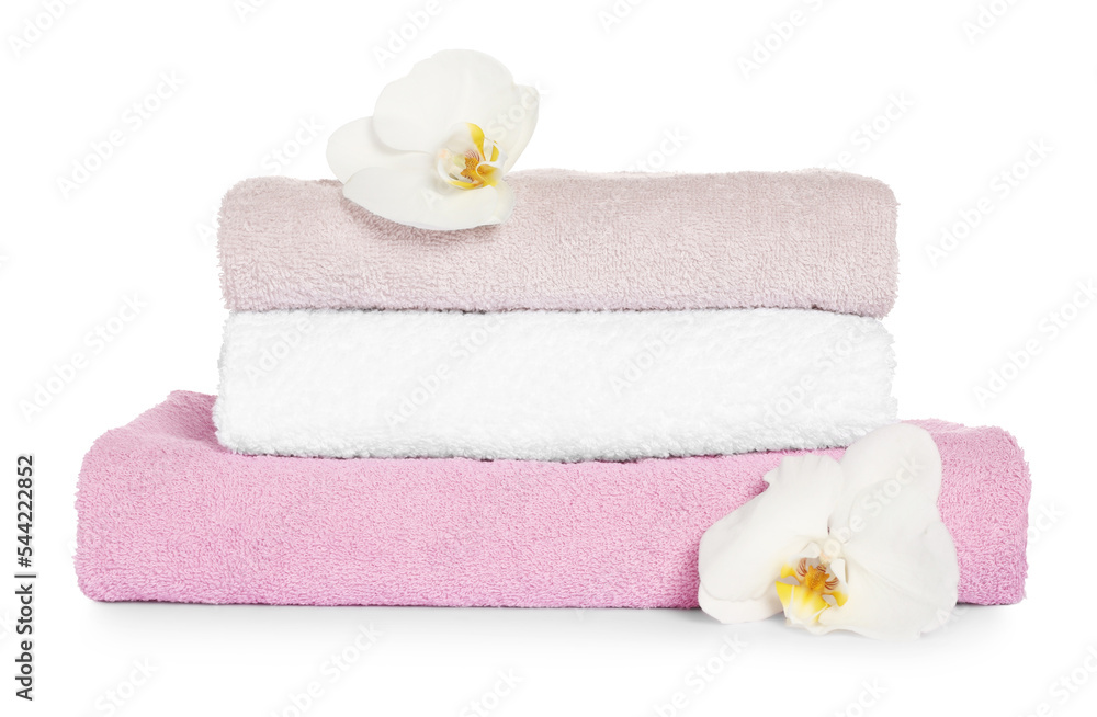 Stack of clean soft towels with orchids isolated on white Stack of clean soft towels with orchids isolated on white