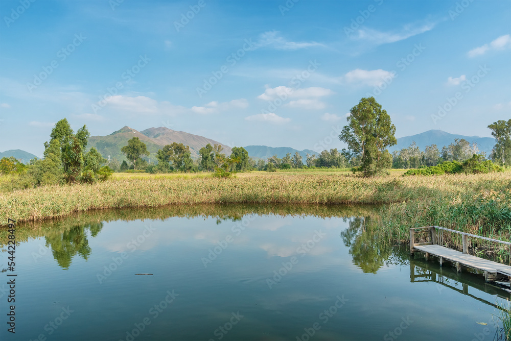 Idyllic landscape of lake and old wooden fishing Jetty in Nam Sang Wai, Yuen Long, New Territories, Hong Kong, China