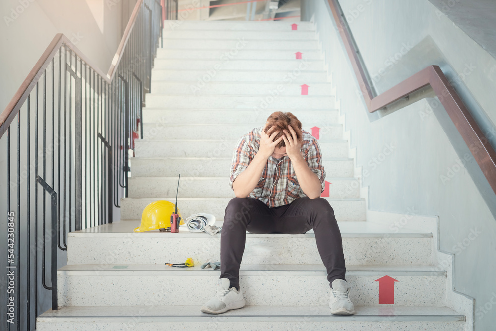 Fototapeta premium Asian construction workers tired sad from stress from hard-working