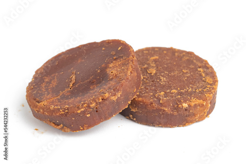 cylindrical dark brown sugar or palm sugar isolated on white background © Dadan