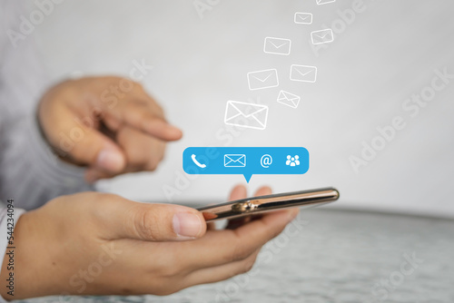Contact us or Customer support hotline people connect. Business people using a smartphone with the (email, call phone, mail) icons.