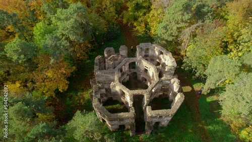 Aerial drone bird's eye view over Letohradek ruins surrounded by dense vegetation during autumn morning in Czech republic. photo