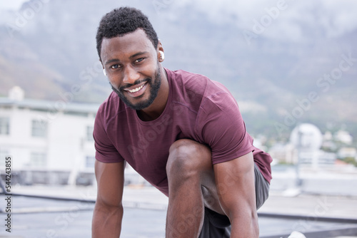 Black man, music earphones and fitness start for exercise, training or workout in Nigeria city for health, wellness or heart cardio. Portrait, smile or happy runner listening to motivation podcast