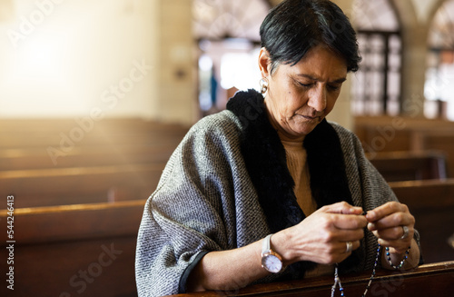 Fototapeta Pray, senior woman and praying in church with a rosary for religion, worship and God praise, peaceful and calm