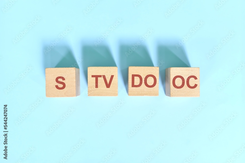 S TV DO OC basic sentence pattern English grammar concept. Wooden blocks flat lay on blue background.