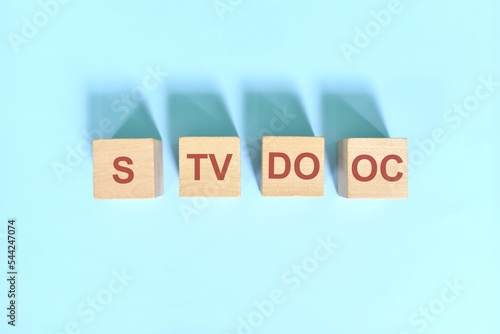 S TV DO OC basic sentence pattern English grammar concept. Wooden blocks flat lay on blue background. photo