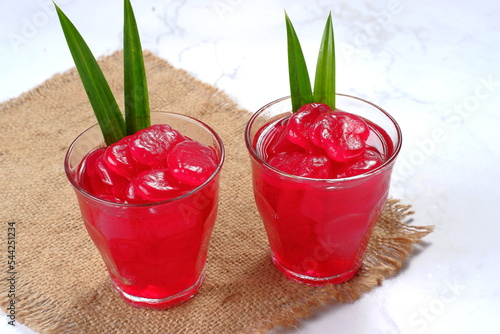 manisan kolang kaling ,preserved sugar palm fruit,tinted red with red syrup and paste  .an indonesian typical refreshment and dessert during ramadan month and hari raya idul fitri photo