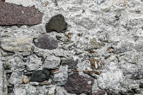 Steinmauer mit naturbelassenen Steinen und Moos als Hintergrund mit Textfreiraum photo