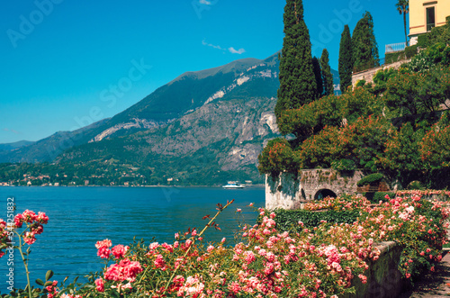 Beautiful view of Lake Como and Alpine mountains visible from the botanical garden of Villa Cipressi, Varenna, Italy. Italian landscape, on a sunny summer day. photo