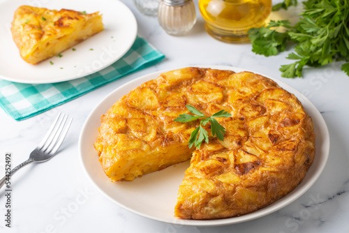 Obraz na płótnie Spanish omelette with potatoes, typical spanish cuisine on gray concrete floor. Tortilla Espanola. Turkish name; Yumurtali patates w salonie