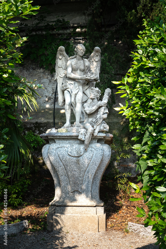 Beautiful ancient sculptures in the botanical garden of the famous mediterranean Villa Monastero, located in traditional village of Varenna, Province of Lecco, on the shore of Lake Como, Italy.