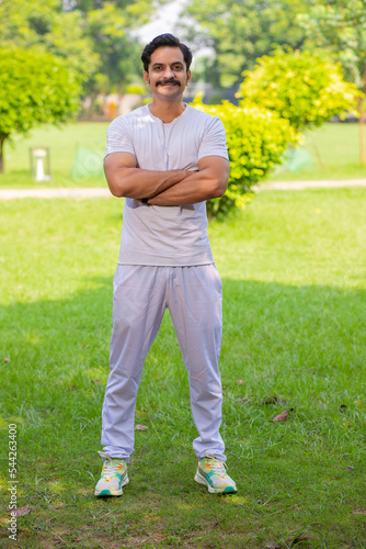Young indian man giving expression after yoga and workout in park.