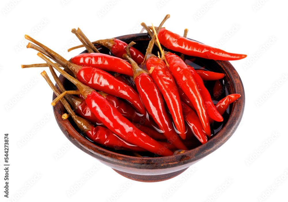 Clay cup with pickled chili peppers isolated on white background. Full clipping path. Clay cup with pickled chili peppers isolated on white background. Full clipping path.