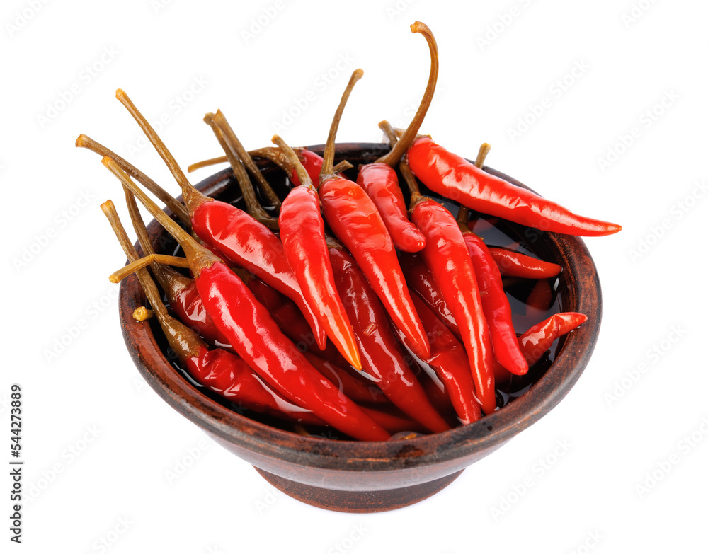 Clay cup with pickled chili peppers isolated on white background. Full clipping path. Clay cup with pickled chili peppers isolated on white background. Full clipping path.